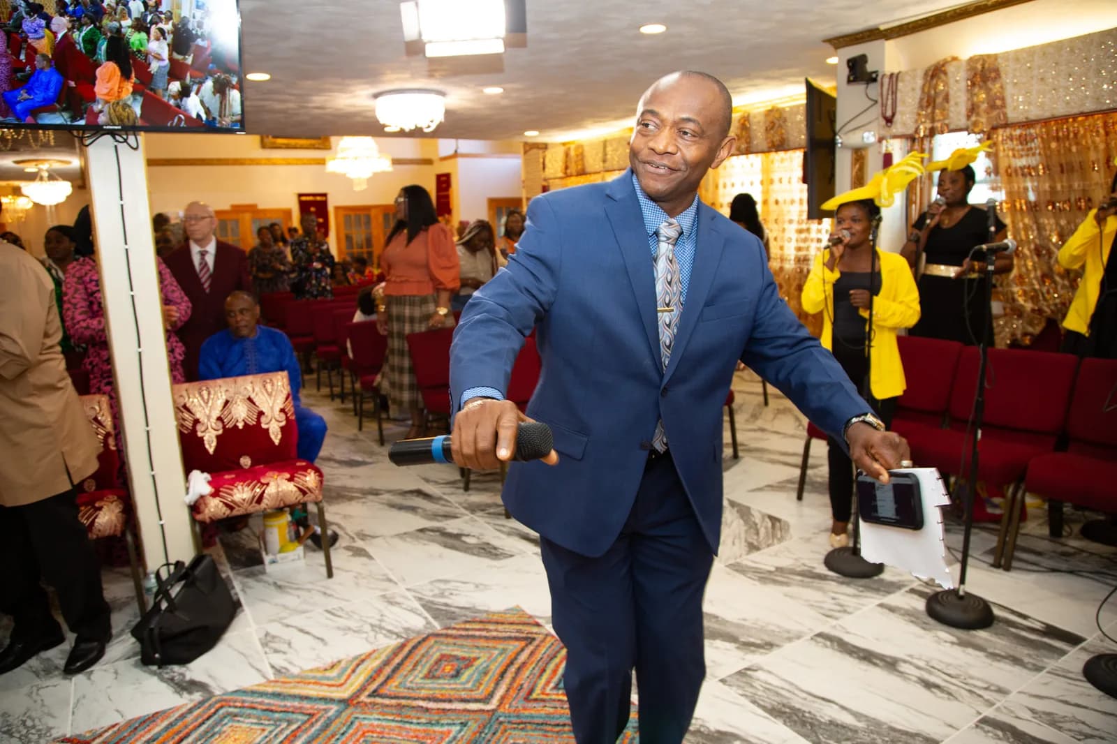Pastor dancing joyfully in the sanctuary aisle — whole room in view