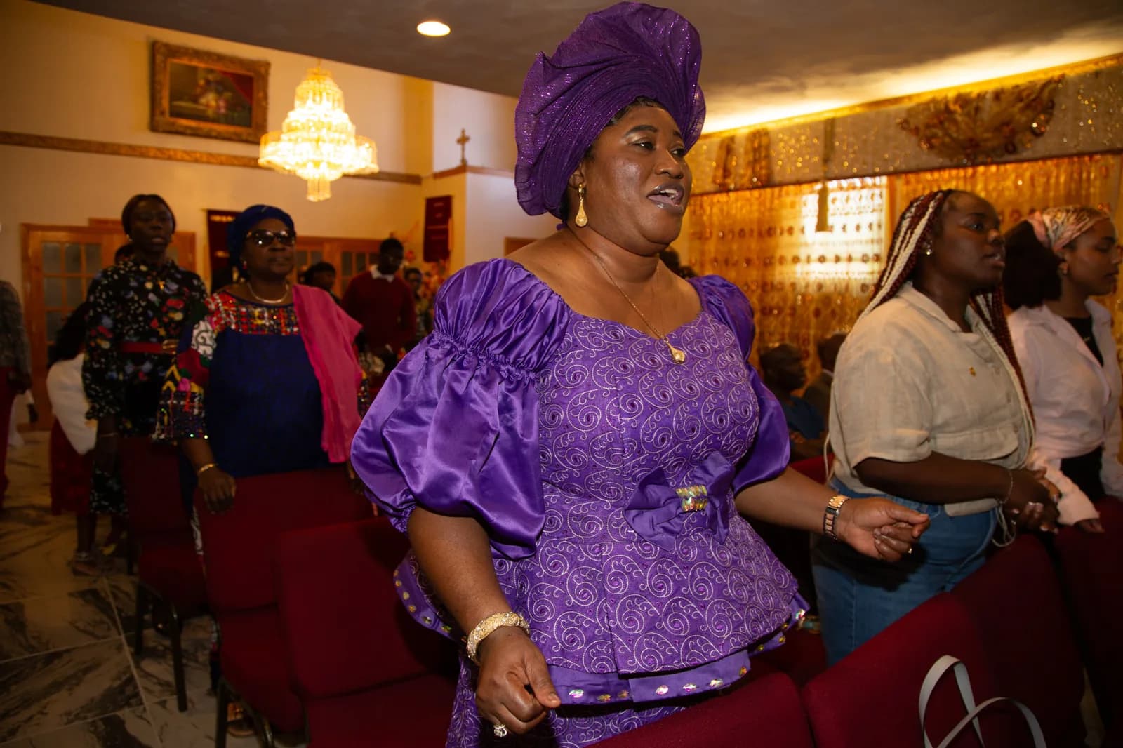 Woman in vivid purple lace joyfully dancing down the aisle